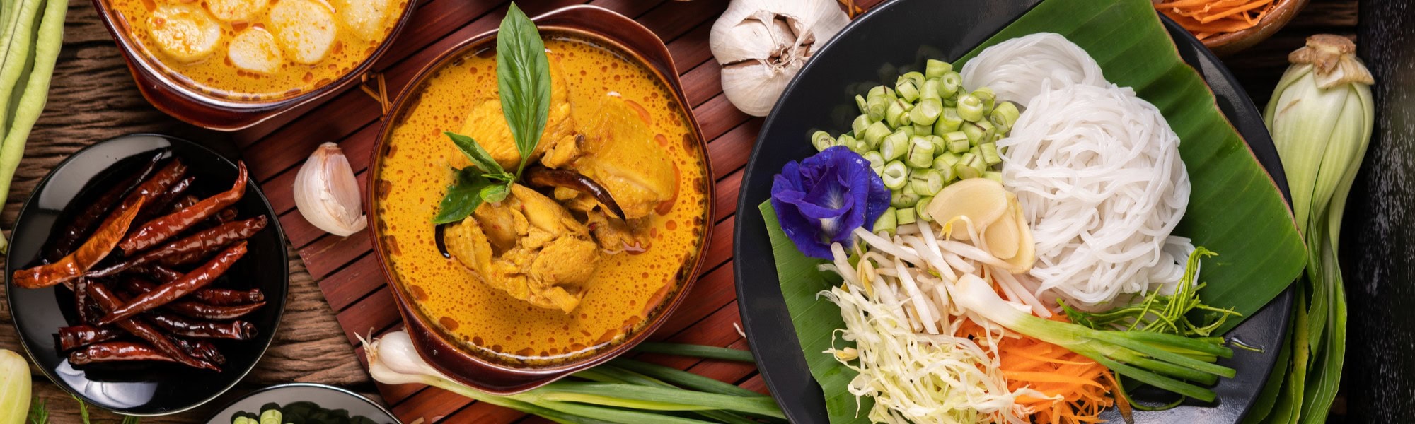 Rice noodles in a bowl of curry paste with chili