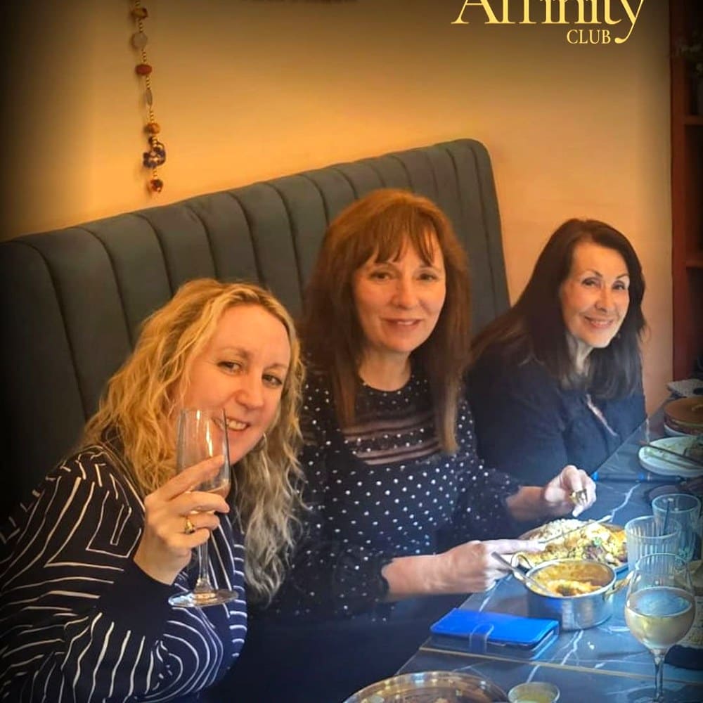 Friends sharing Indian tapas at an Affinity Club dining night in Nottingham