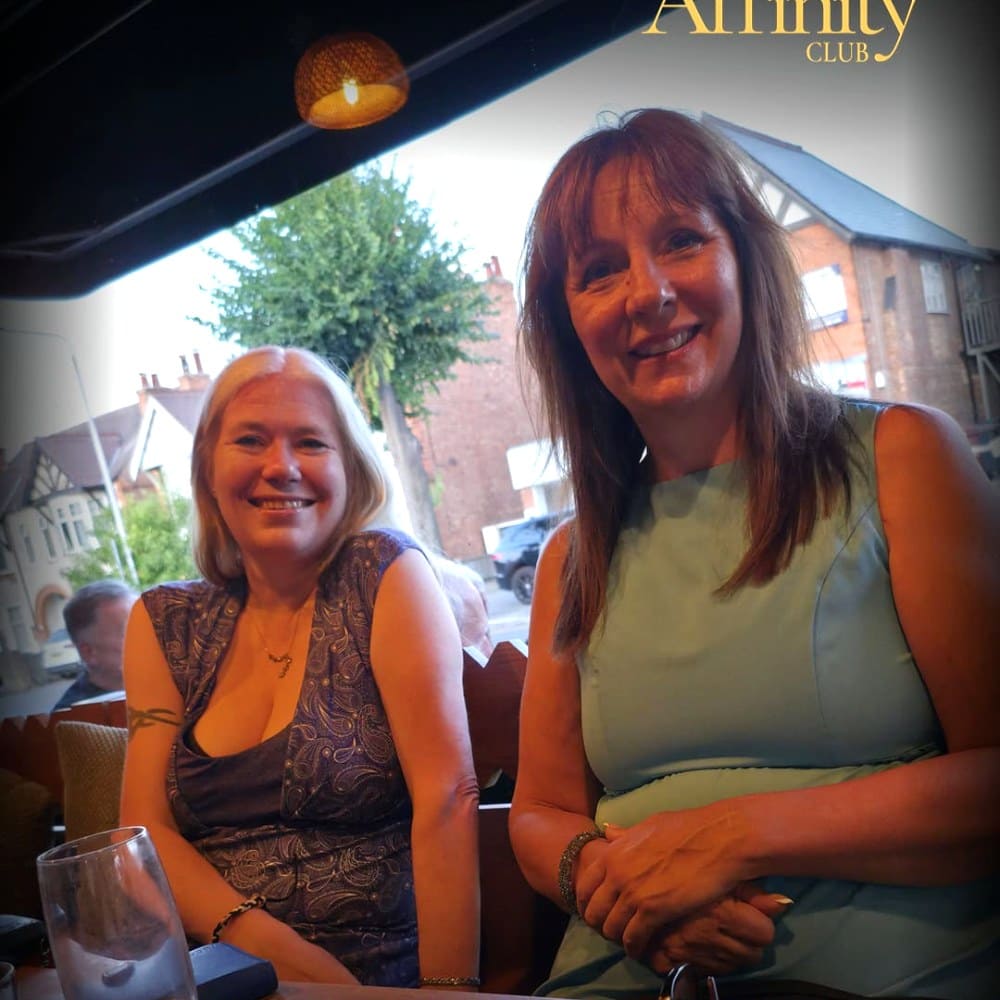 Two Affinity Club members smiling at a dining event in Nottingham